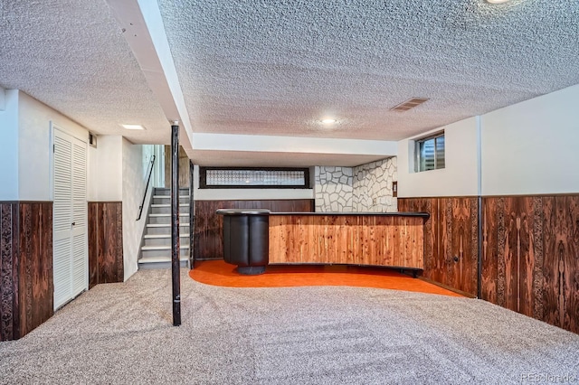 9270 Tennyson St, Westminster, CO 80031 - indoor dry bar with a textured ceiling, wainscoting, wood walls, carpet floors, and stairs