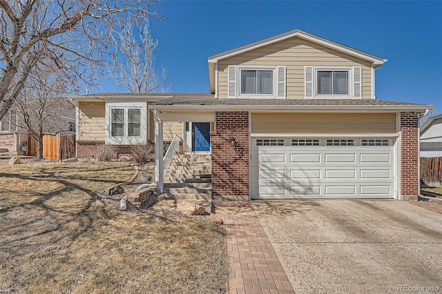 split level home featuring concrete driveway, brick siding, fence, and an attached garage