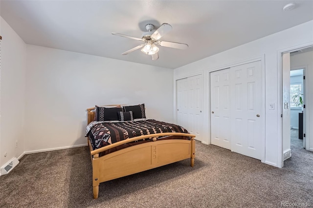 carpeted bedroom featuring baseboards, visible vents, ceiling fan, and multiple closets