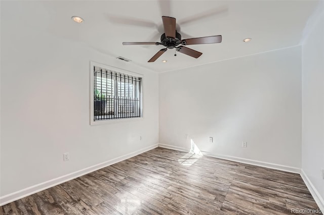 empty room featuring recessed lighting, visible vents, ceiling fan, wood finished floors, and baseboards