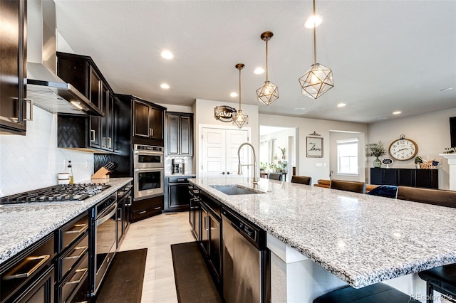 kitchen with hanging light fixtures, backsplash, a breakfast bar area, stainless steel appliances, and a spacious island