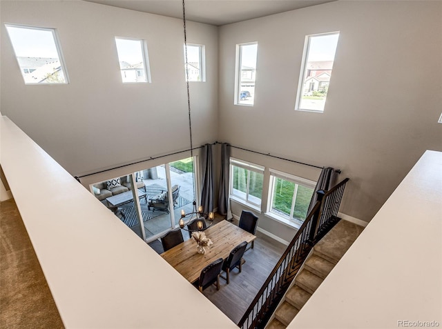 stairway with a wealth of natural light and wood-type flooring