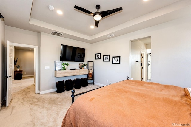 bedroom featuring a tray ceiling, ceiling fan, and light colored carpet