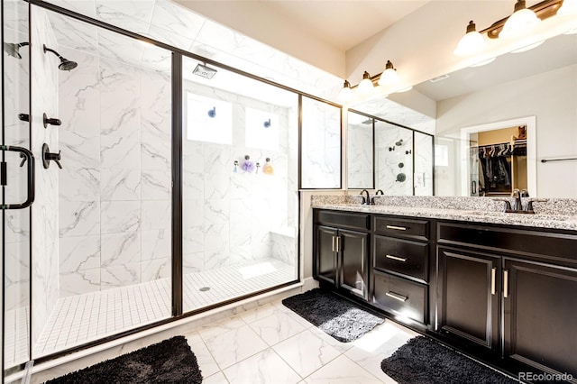 bathroom featuring vanity and a shower with shower door