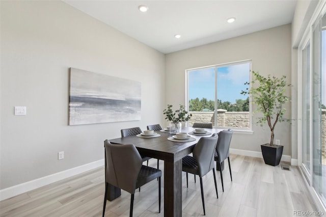 dining space featuring light wood-type flooring