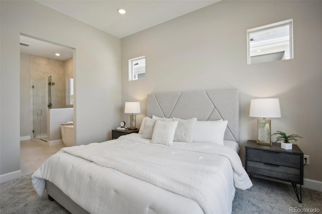 bedroom featuring ensuite bath and light carpet