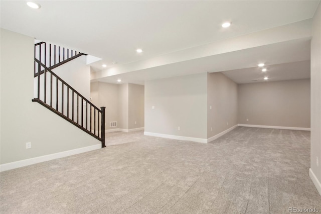 basement featuring light colored carpet