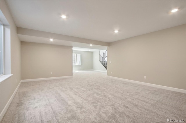 basement featuring light carpet