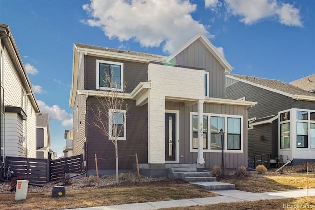 view of front facade featuring fence and board and batten siding