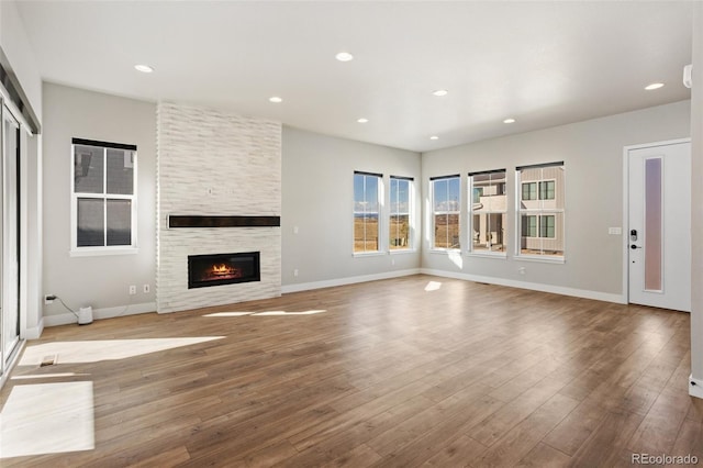 unfurnished living room with light wood-style flooring, baseboards, and recessed lighting