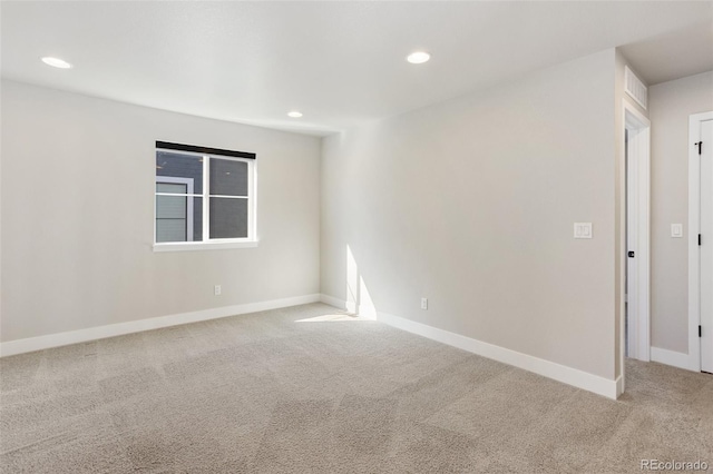 carpeted spare room with recessed lighting and baseboards