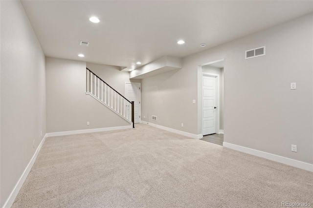 basement featuring recessed lighting, visible vents, baseboards, and stairs