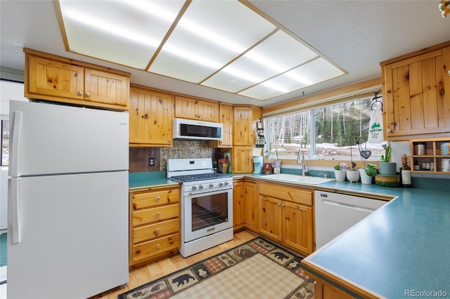 153 Gcr 135, Kremmling, CO 80459 - kitchen with white appliances, a sink, light wood-style floors, light countertops, and tasteful backsplash