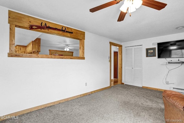 153 Gcr 135, Kremmling, CO 80459 - unfurnished living room featuring a ceiling fan, carpet flooring, a baseboard radiator, and baseboards