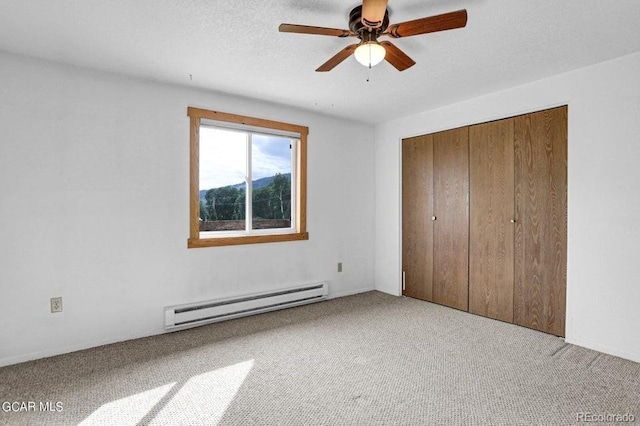 153 Gcr 135, Kremmling, CO 80459 - unfurnished bedroom with a baseboard radiator, carpet floors, a closet, and a ceiling fan