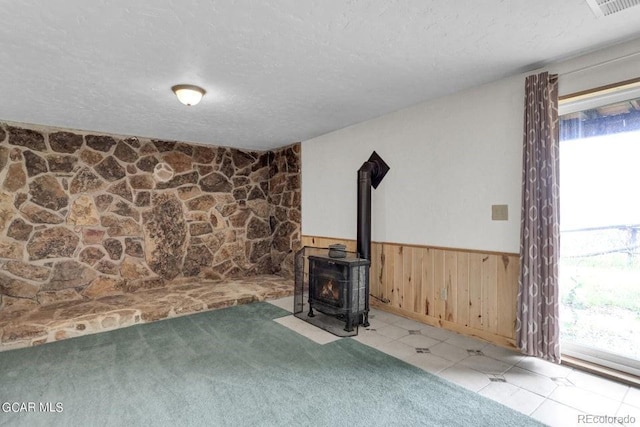 153 Gcr 135, Kremmling, CO 80459 - unfurnished living room with a textured ceiling, a wainscoted wall, and plenty of natural light