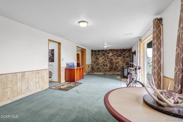 153 Gcr 135, Kremmling, CO 80459 - living area with wood walls, wainscoting, and carpet