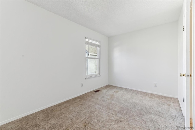 3121 S Estes St, Lakewood, CO 80227 - unfurnished room featuring light carpet, visible vents, baseboards, and a textured ceiling