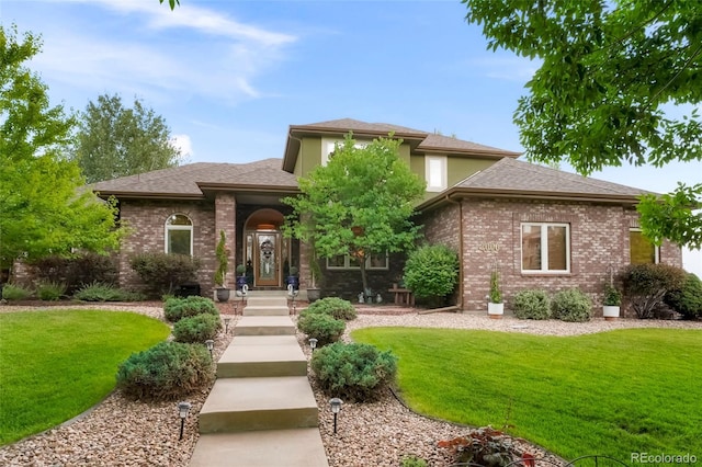 prairie-style home featuring a front lawn