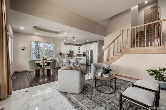 living room featuring a tray ceiling