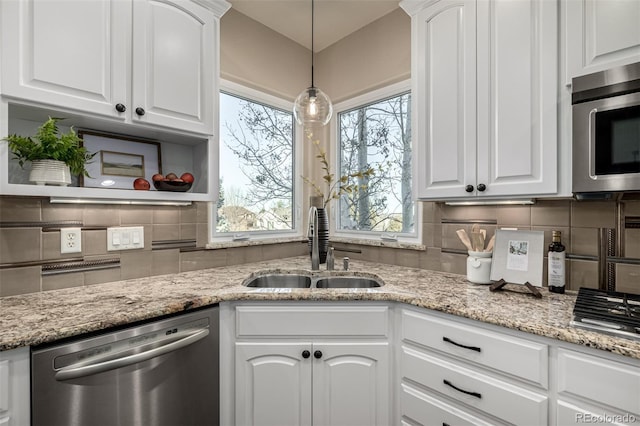 kitchen with white cabinets, appliances with stainless steel finishes, and sink