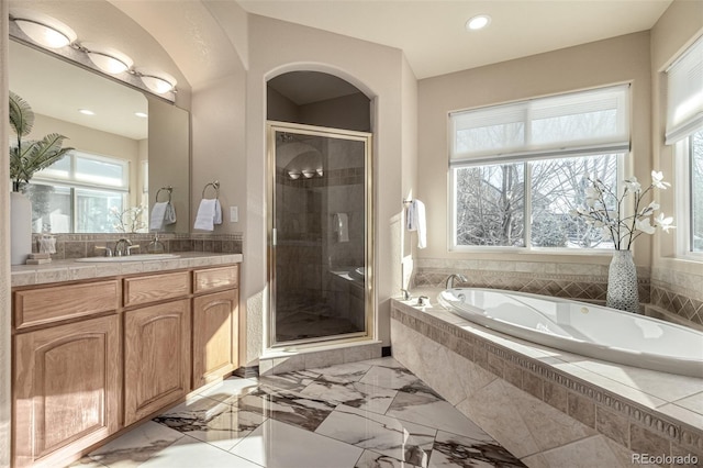 bathroom with vanity and separate shower and tub