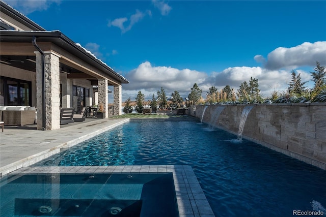 view of pool featuring pool water feature and a patio area