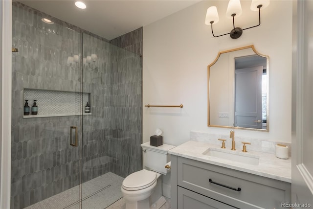 bathroom featuring walk in shower, vanity, and toilet