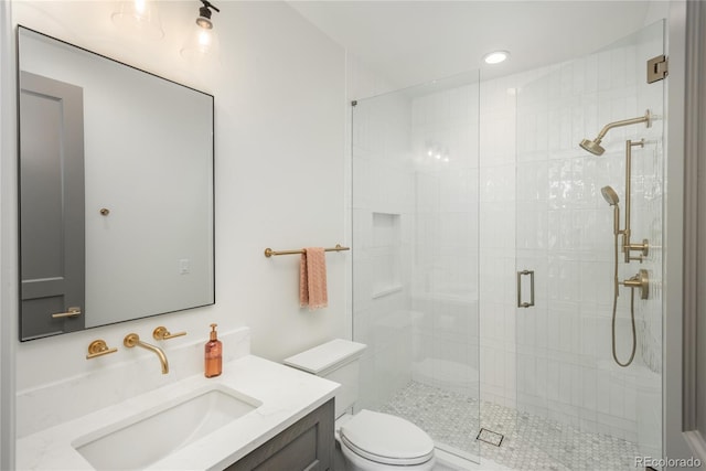 bathroom with walk in shower, vanity, and toilet