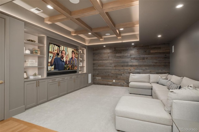 home theater featuring wood walls, beamed ceiling, coffered ceiling, built in features, and light wood-type flooring