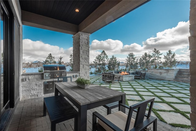 view of patio with exterior kitchen, a grill, and an outdoor hangout area