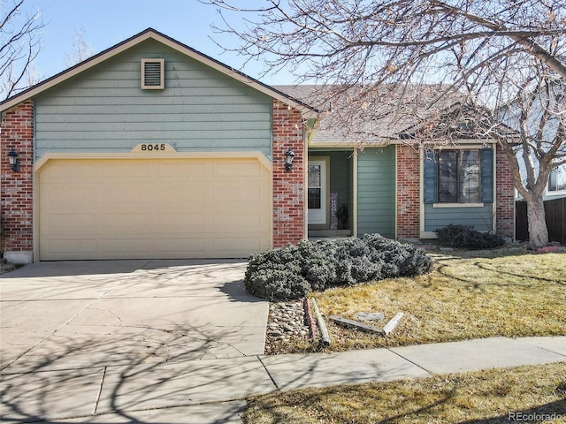 ranch-style home with a garage, concrete driveway, and brick siding