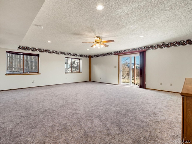 carpeted empty room featuring a ceiling fan, recessed lighting, a textured ceiling, and baseboards