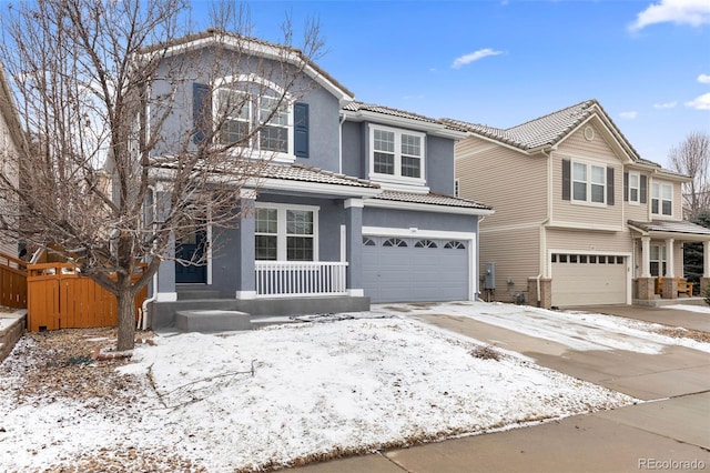 traditional home featuring stucco siding, an attached garage, fence, driveway, and a tiled roof