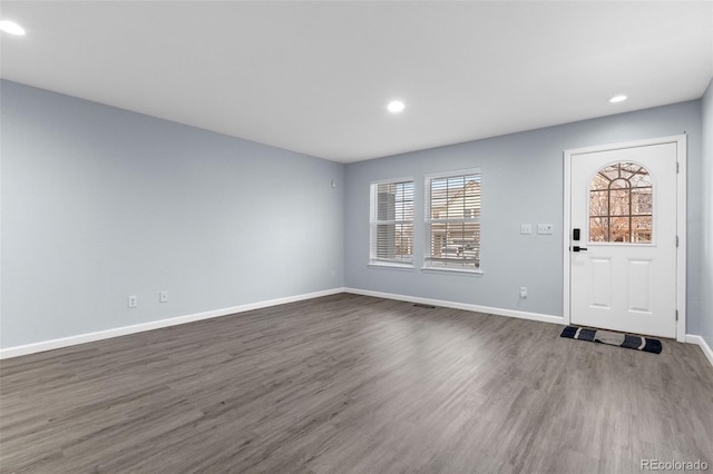 foyer entrance with baseboards, dark wood finished floors, and recessed lighting