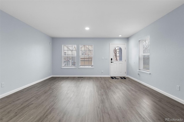 foyer entrance featuring dark wood-style floors, baseboards, and recessed lighting