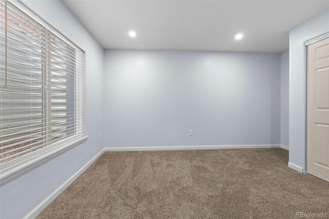 empty room featuring baseboards, carpet flooring, and recessed lighting