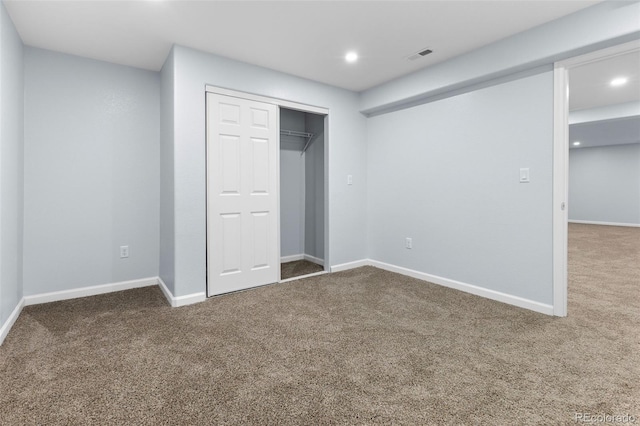 unfurnished bedroom with carpet, recessed lighting, a closet, visible vents, and baseboards