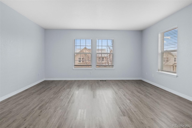 empty room with wood finished floors and baseboards