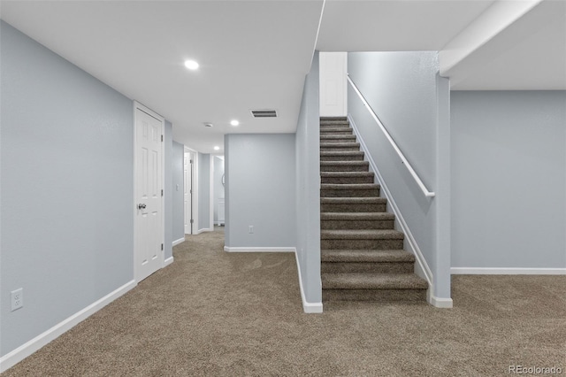 staircase with baseboards, visible vents, carpet flooring, and recessed lighting