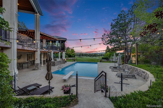 10914 Remmick Ridge Rd, Parker, CO 80134 - pool at dusk with a patio area and an outdoor pool