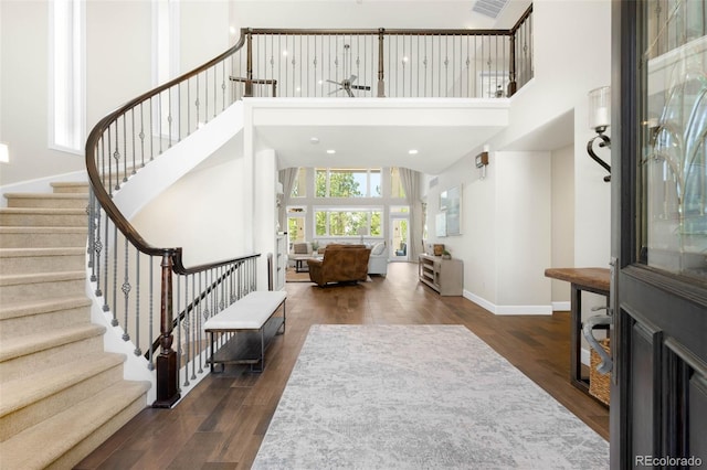 10914 Remmick Ridge Rd, Parker, CO 80134 - foyer entrance featuring a high ceiling, stairway, wood finished floors, and baseboards