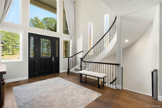 10914 Remmick Ridge Rd, Parker, CO 80134 - entryway with a towering ceiling, baseboards, stairway, hardwood / wood-style flooring, and recessed lighting