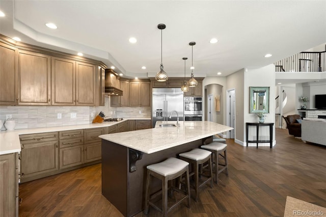 10914 Remmick Ridge Rd, Parker, CO 80134 - kitchen with stainless steel appliances, a sink, premium range hood, arched walkways, and dark wood-style floors