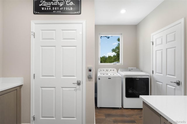 10914 Remmick Ridge Rd, Parker, CO 80134 - washroom featuring washing machine and clothes dryer, dark wood-style floors, and cabinet space