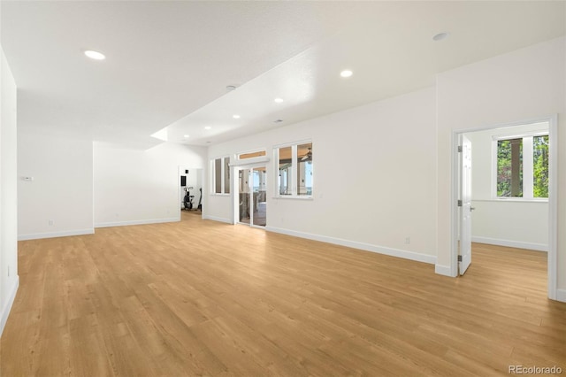 10914 Remmick Ridge Rd, Parker, CO 80134 - unfurnished living room with light wood finished floors, baseboards, and recessed lighting