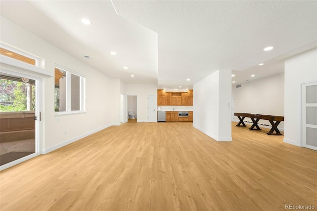 10914 Remmick Ridge Rd, Parker, CO 80134 - unfurnished living room featuring light wood-type flooring, recessed lighting, and baseboards