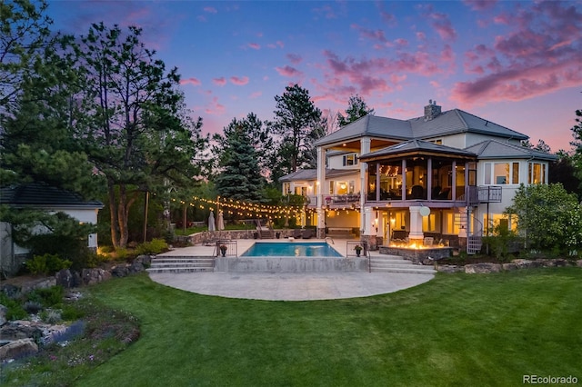 10914 Remmick Ridge Rd, Parker, CO 80134 - back of house with a patio area, a lawn, an outdoor pool, and a chimney