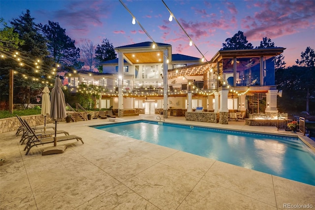 10914 Remmick Ridge Rd, Parker, CO 80134 - pool at dusk with a patio and an outdoor pool