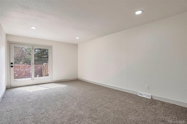 12164 E Amherst Cir, Aurora, CO 80014 - empty room featuring a textured ceiling, light carpet, baseboards, and visible vents